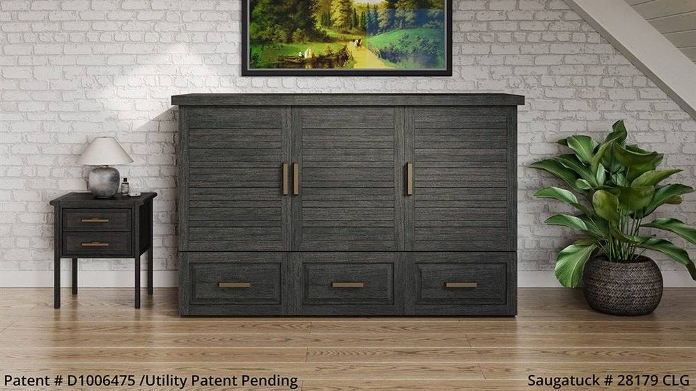Closed credenza bed that looks like a dark wood cabinet with drawers, below a framed landscape painting