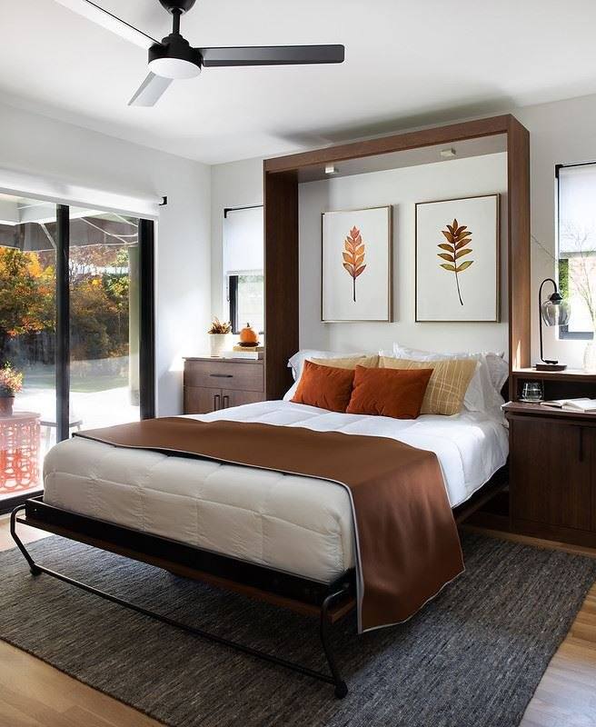Open Murphy bed with a wood-tone headboard panel in a bedroom with a ceiling fan