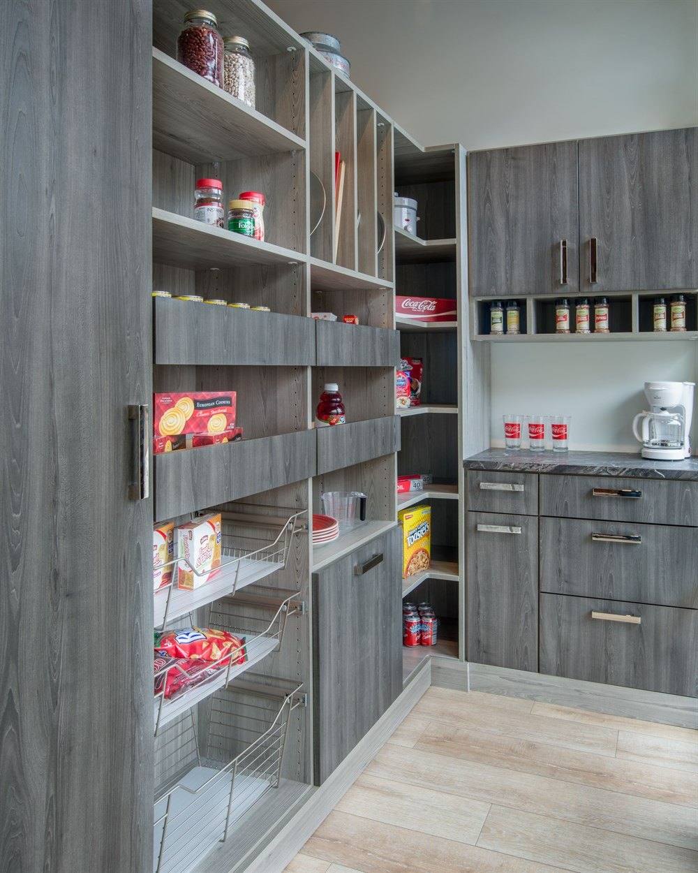 Walk-in pantry with gray wood-grain adjustable shelving and lower cabinets